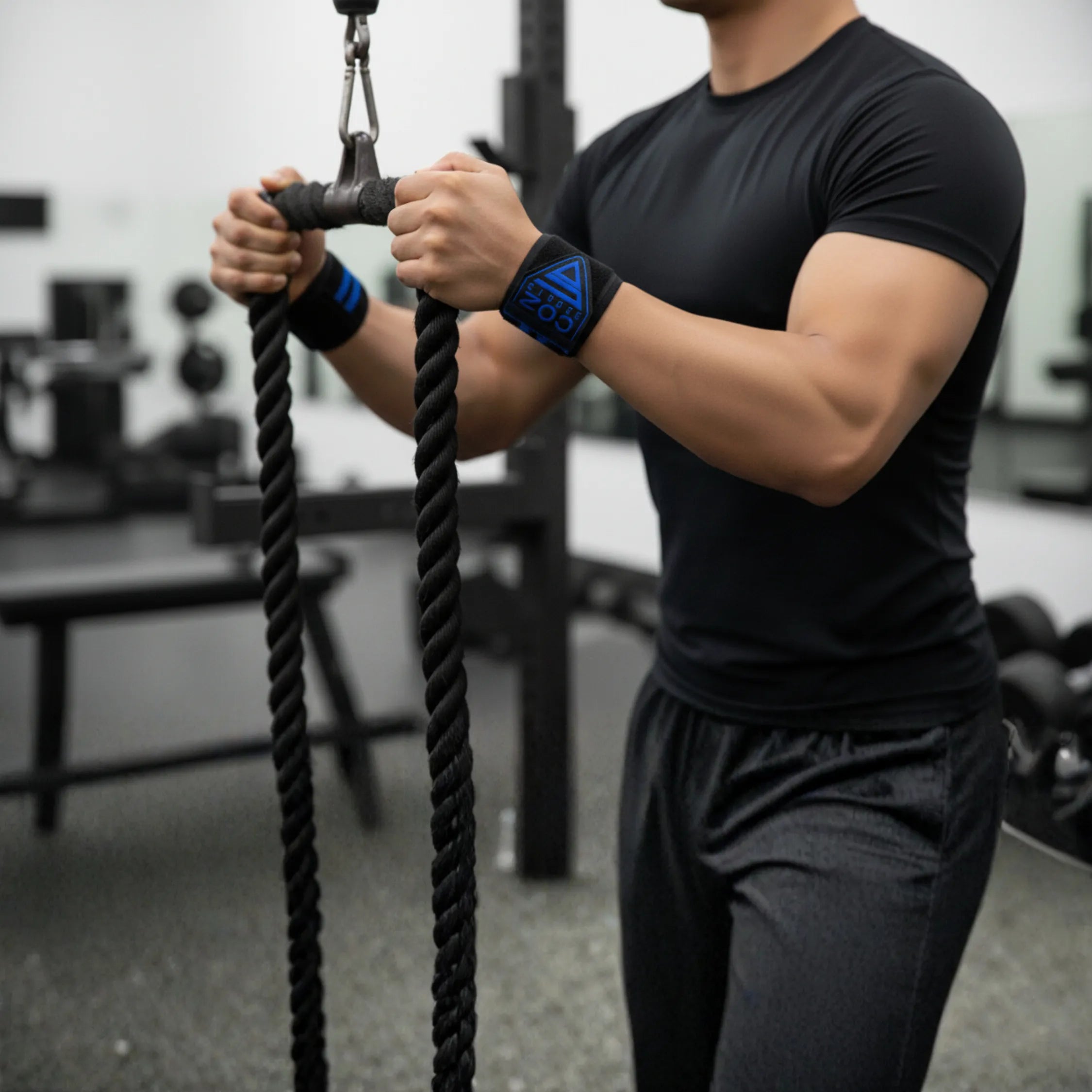 “Man training with gym battle ropes wearing CO2 Sports wrist wraps – gym fitness accessories collection”