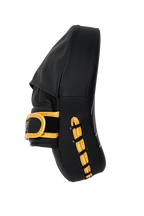 Black and gold equestrian leg guard on a white background