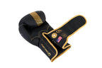 Black boxing glove with gold accents on a white background