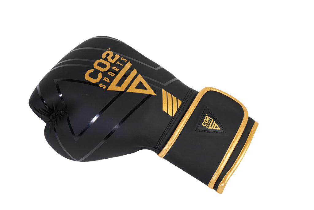 Black boxing glove with gold accents on a white background