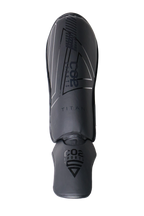 Black shin guard with branding on a white background