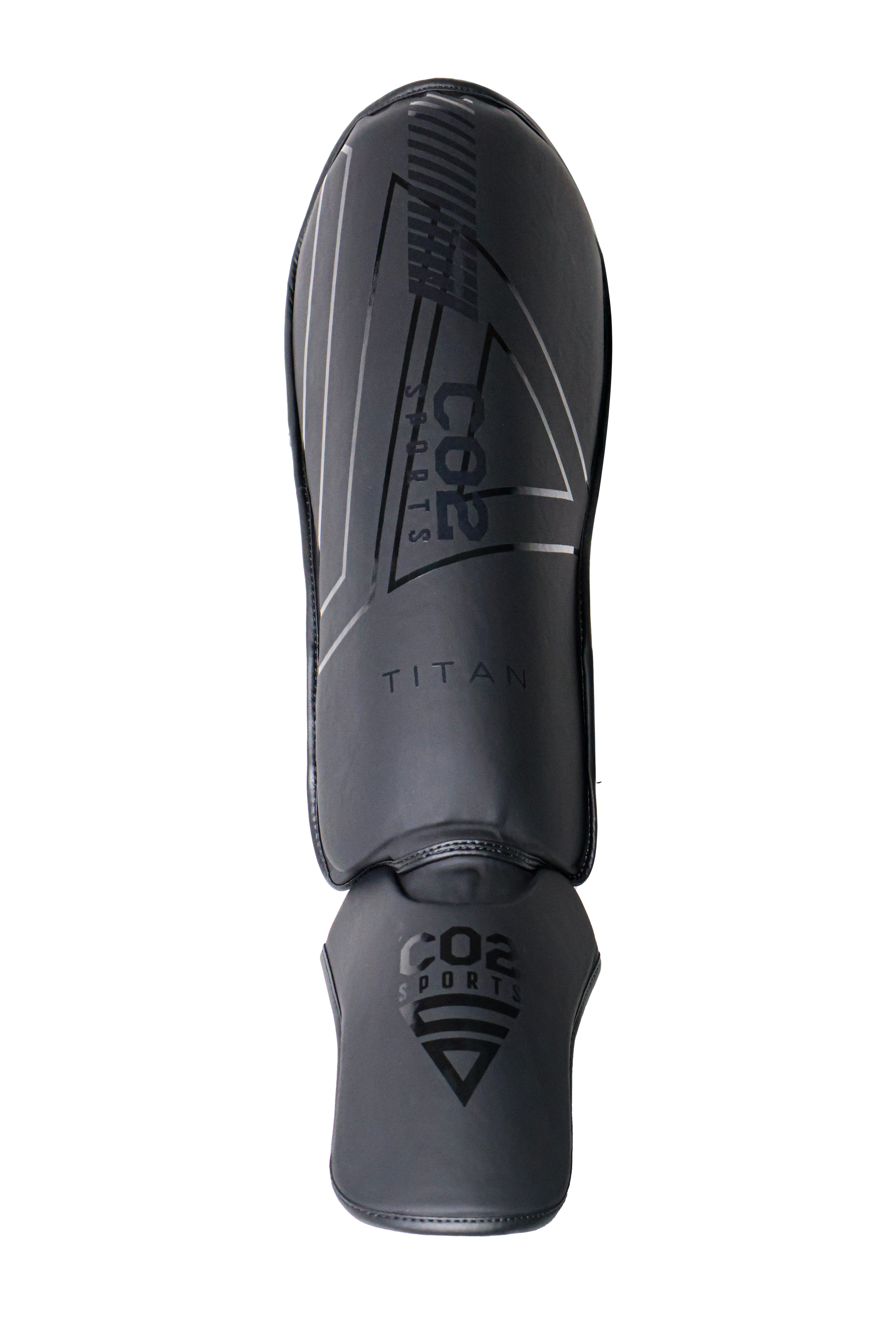 Black shin guard with branding on a white background