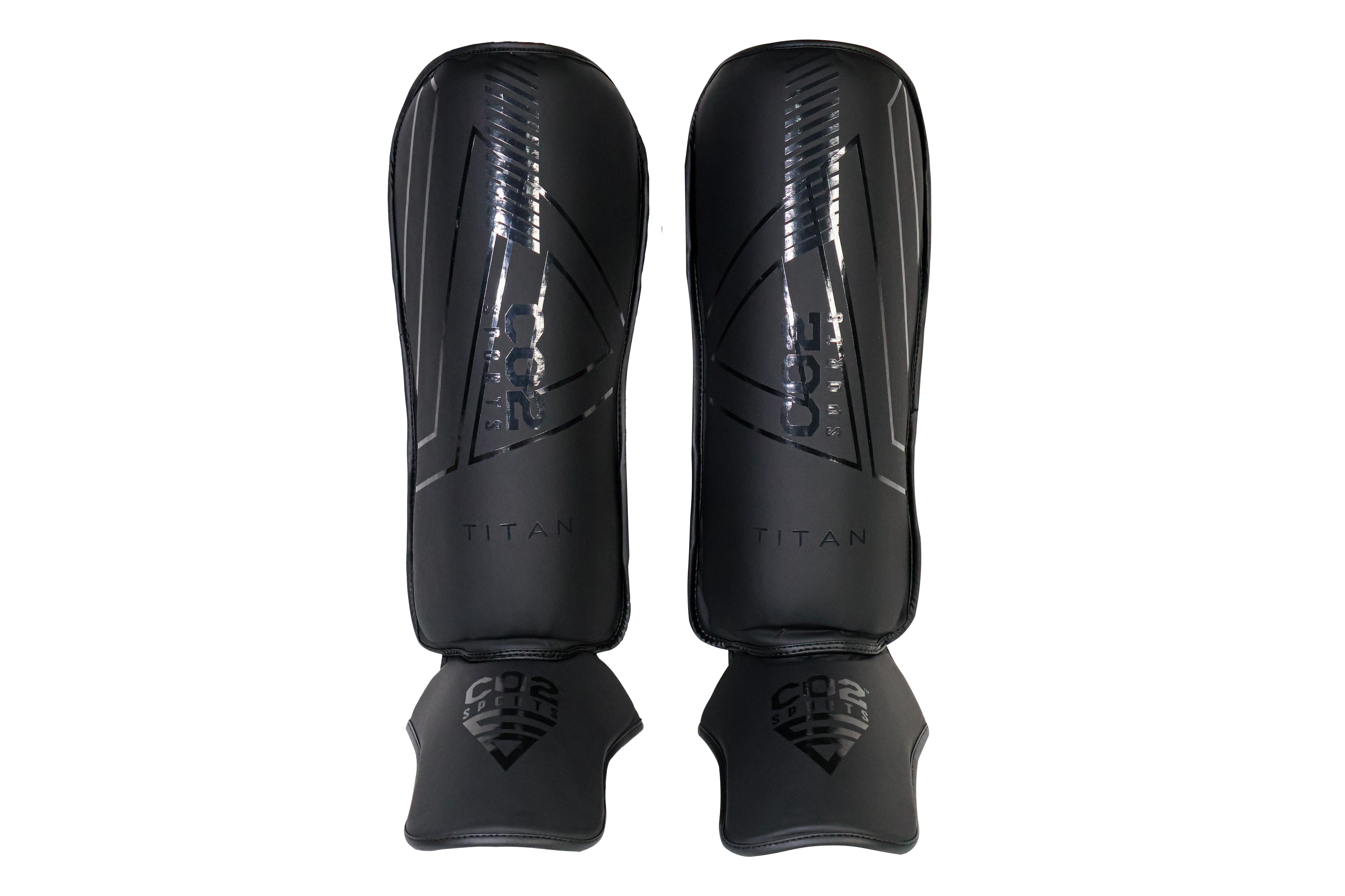 Pair of black shin guards with 'Titan' branding on a white background