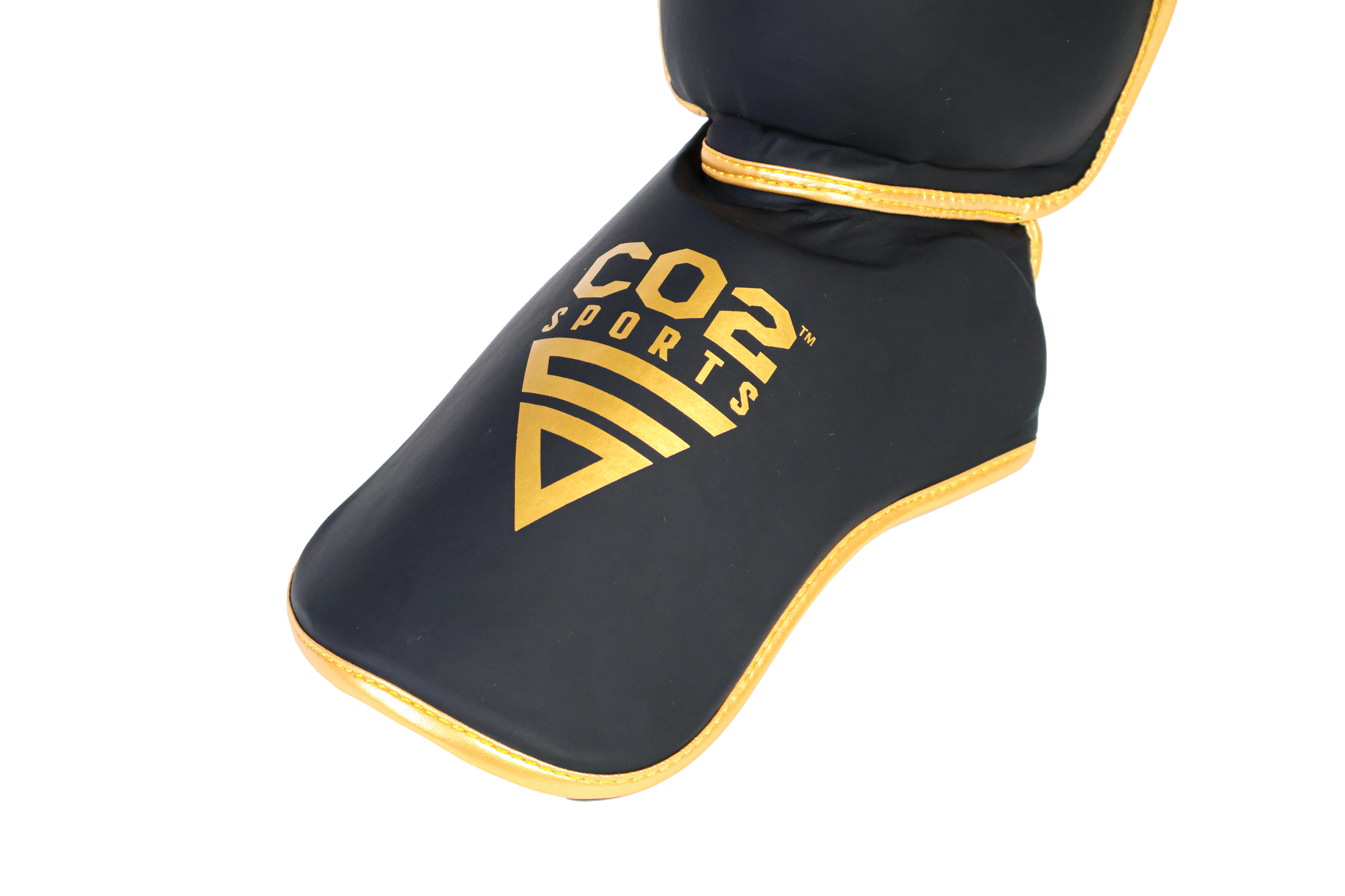 Black shin guard with gold accents and 'Cos Sports' logo on a white background