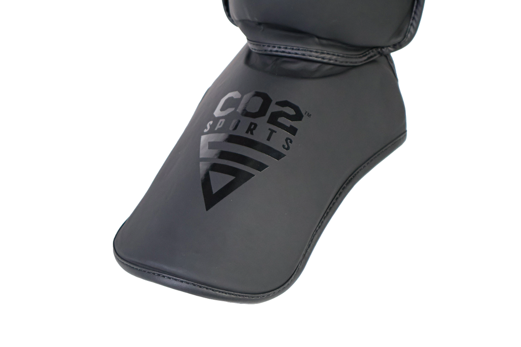 Black shin guard with 'CO2 Sports' branding on a white background