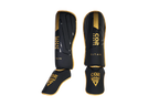 Black and gold shinguards with 'CO2 Sports' branding on a white background